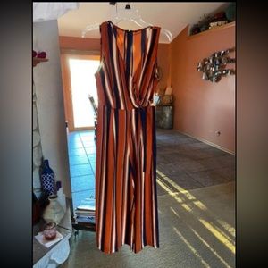 Striped jumpsuit with side tie with metal accent.